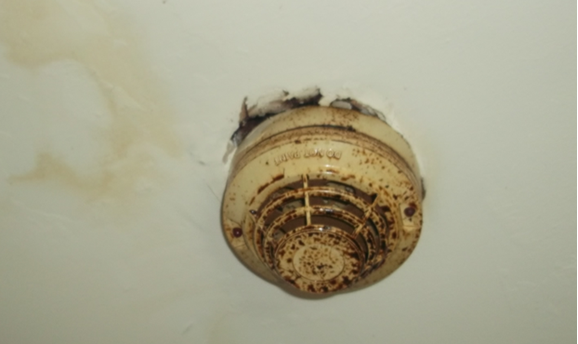 a dirty and broken fire alarm at the HMO in Hucknall 