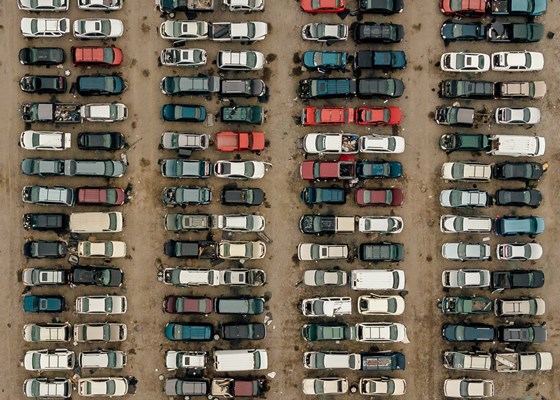 Aerial view of lines of cars in a car park or junk yard