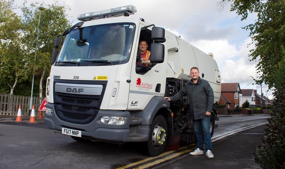 Cllr Jason Zadrozny pictured with a street sweeper in hucknall 