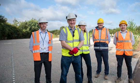 Cllr Matthew Relf stands with 3 men and a woman all in high vis vests, on the new car park