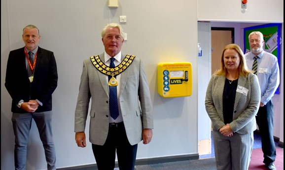 Council Chairman Arnie Hankin with a defibrillator 