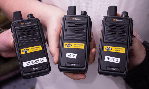 3 of the shop radios held by shop representatives 