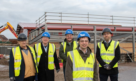 Councillors standing in front of the steel structure for the new pool at Hucknall leisure centre 