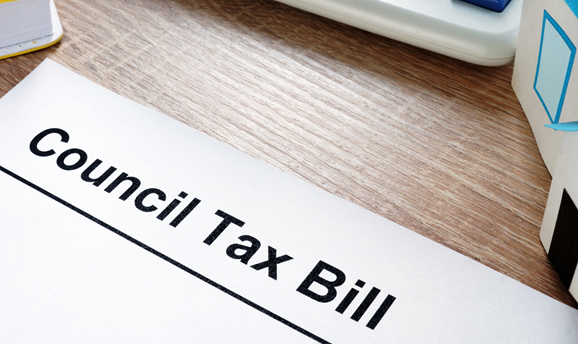 A Council Tax bill on a table with a calculator, Council pays rebate to 25,000 households 