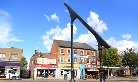 Sutton town centre facing the sundial and shops in the background