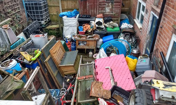 Uncleared rubbish in resident's garden