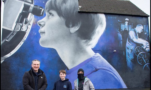 Cllr Matthew Relf, Freya, and Zabou in front of the mural in Sutton 