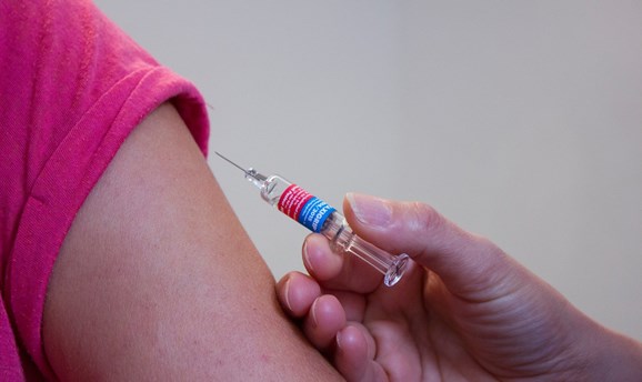 Vaccine being administered into an arm