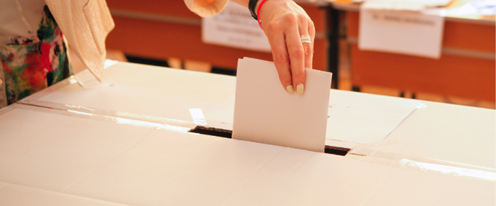 Voting slip being placed into a ballot box