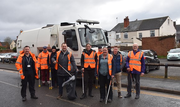Refuge vehicle on street with councilors, volunteers and picking equipment 